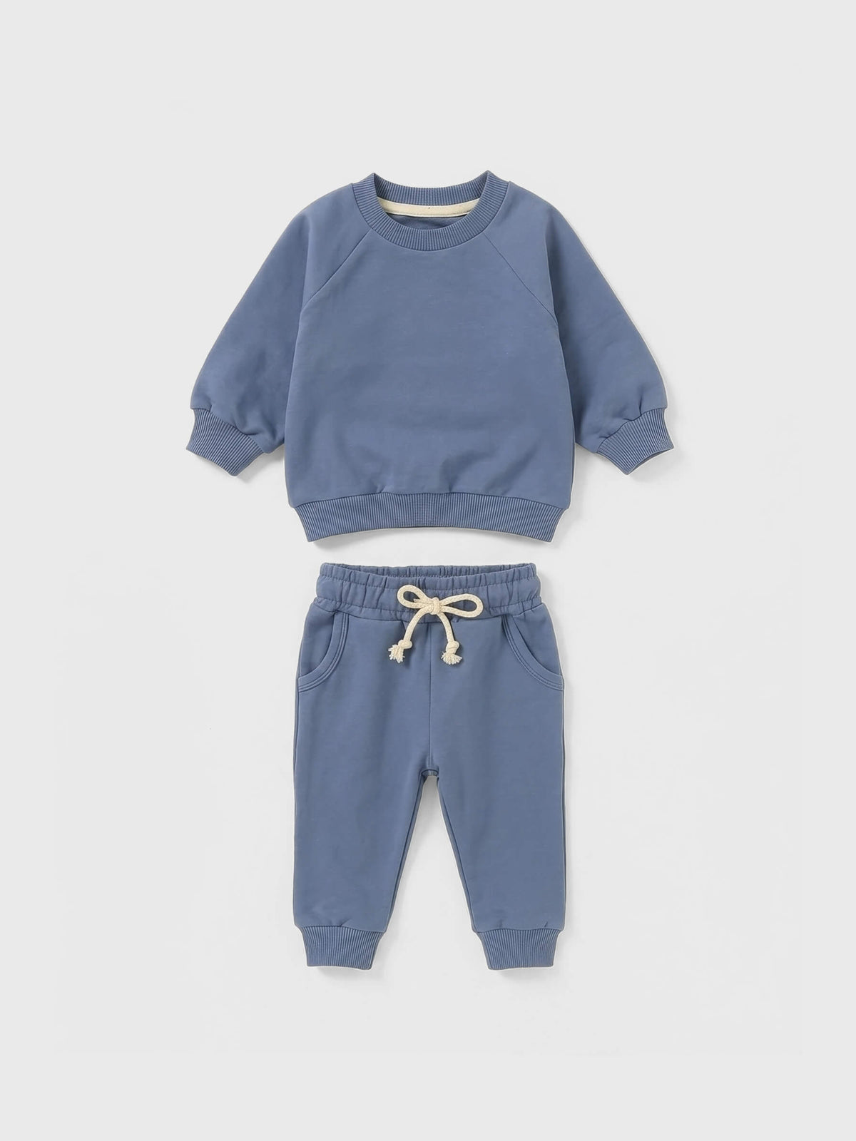 Children's blue sweatshirt and pants set on a light gray background