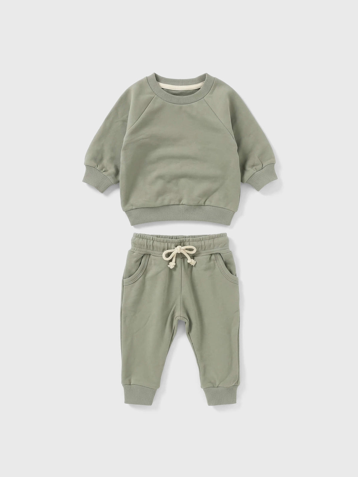 Children's green sweatshirt and pants set on a white background