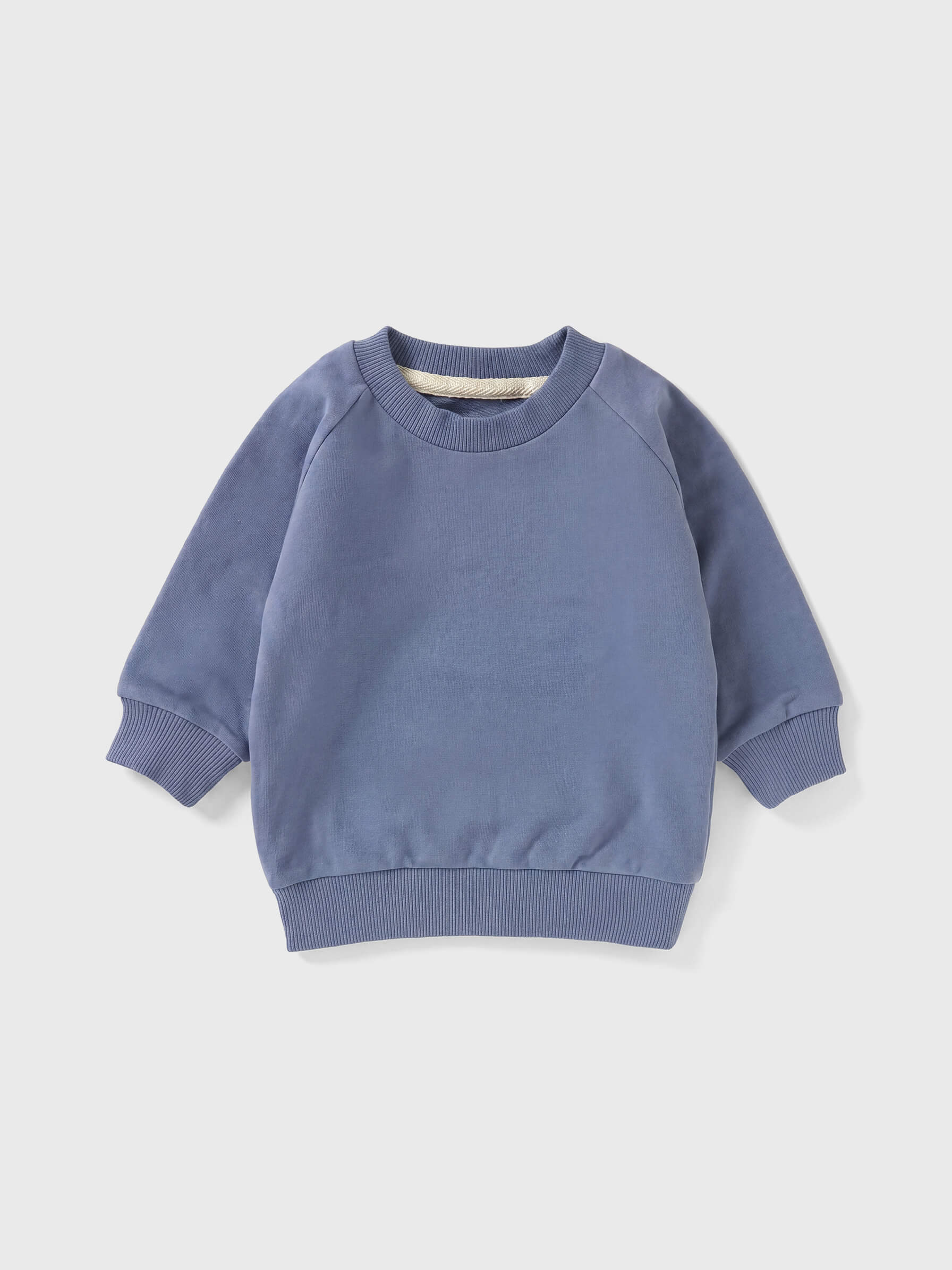Blue children's sweatshirt on a light gray background
